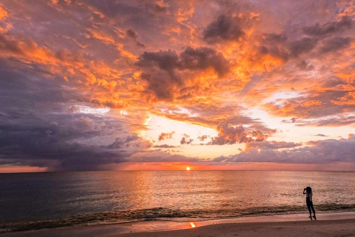A tourist take a picture sunset at Bradenton Beach Florida